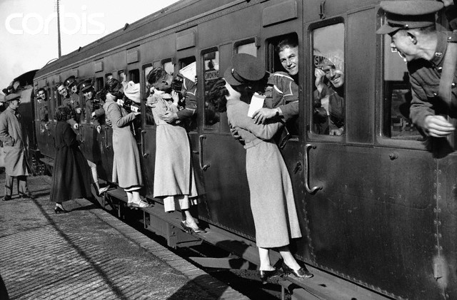 September 1935, London, England, UK --- Leaning out of train windows at Feltham Station, soldiers departing for Egypt kiss their wives and girlfriends goodbye. September 1935. --- Image by © Hulton-Deutsch Collection/CORBIS
